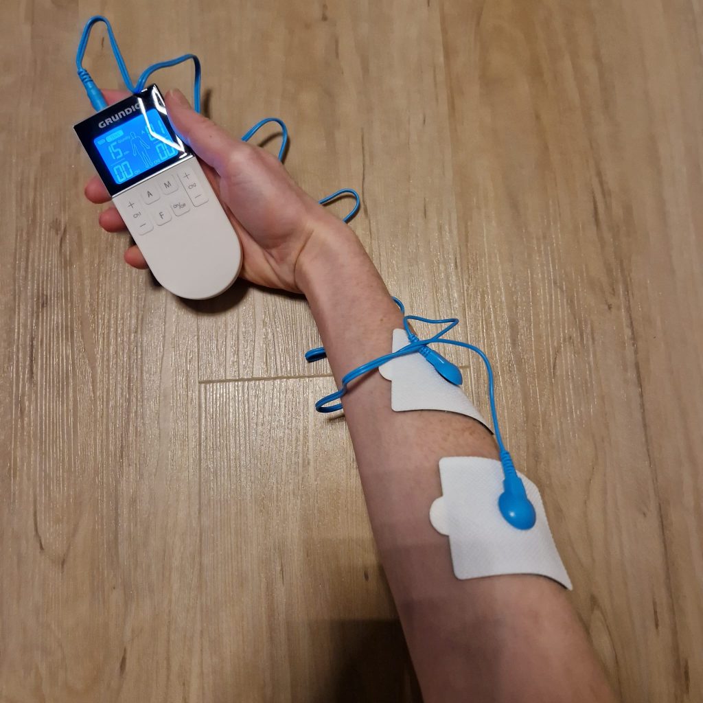 EMS TENS stimulation current therapy device in practical testing